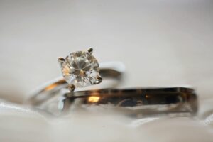 A close-up of a brilliant-cut diamond ring on a minimalist background, representing material integrity and the new 5th C of carbon footprint tracking in luxury jewelry