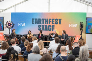 A group of diverse fashion industry experts and policy professionals discussing circular economy solutions on a live panel stage.